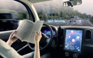 Woman reading a book in a self-driving car